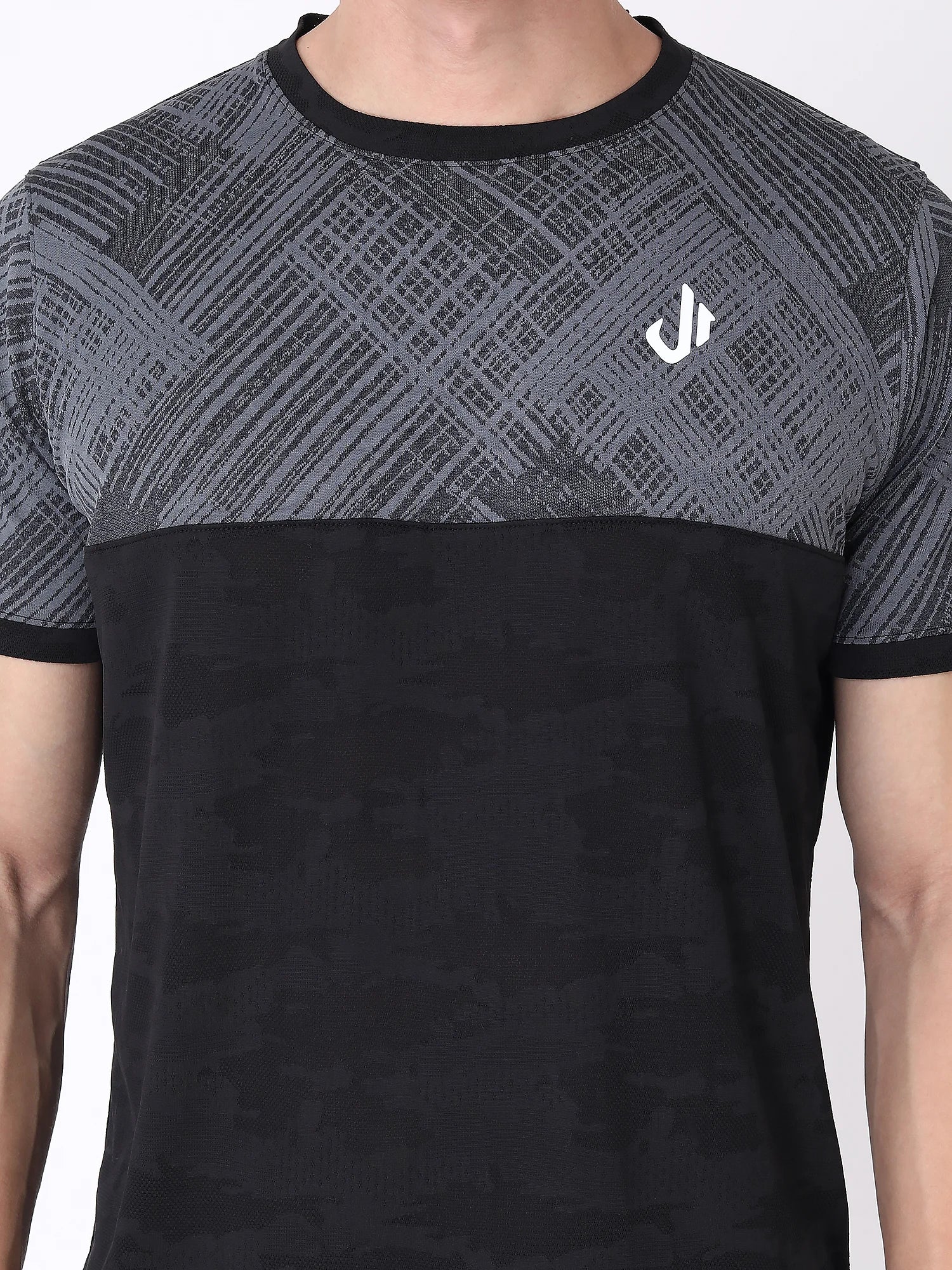 A black and grey camouflage printed t-shirt with a logo on the chest.